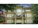 Expansive back exterior with balcony, multiple large windows, and an outdoor seating area at 14515 Nolen Ln, Charlotte, NC 28277