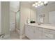 Bathroom featuring a vanity with ample counter space, large mirror, and a shower with glass door at 14515 Nolen Ln, Charlotte, NC 28277
