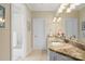Bathroom featuring a vanity with granite counter space, a mirror, and a shower at 14515 Nolen Ln, Charlotte, NC 28277