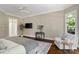 Spacious bedroom features hardwood floors, a ceiling fan and a cozy seating area at 14515 Nolen Ln, Charlotte, NC 28277