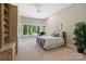 Comfortable bedroom with large windows, a ceiling fan, built-in shelving, and a tranquil view at 14515 Nolen Ln, Charlotte, NC 28277