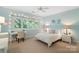 Bright bedroom with a desk, bed, nightstand, and a window letting in natural light at 14515 Nolen Ln, Charlotte, NC 28277