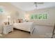 Bright bedroom with a bed, nightstand, and a window letting in natural light at 14515 Nolen Ln, Charlotte, NC 28277