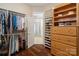 Walk-in closet featuring custom shelving and hardwood floors at 14515 Nolen Ln, Charlotte, NC 28277