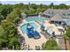 Aerial view of the community center's Gathering pool and play area with a slide and umbrella tables at 14515 Nolen Ln, Charlotte, NC 28277