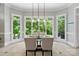 Bright dining room with large windows offering a view of lush greenery at 14515 Nolen Ln, Charlotte, NC 28277