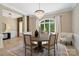 Elegant dining room showcasing a round table, chandelier, and natural light at 14515 Nolen Ln, Charlotte, NC 28277