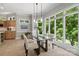 Dining area with modern table, floor to ceiling windows and ample natural light at 14515 Nolen Ln, Charlotte, NC 28277