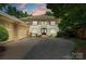Elegant exterior of a home with an attached garage, a paved drive, and manicured landscaping at 14515 Nolen Ln, Charlotte, NC 28277