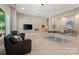 Spacious game room with ping pong table, TV, comfortable seating, and ample lighting at 14515 Nolen Ln, Charlotte, NC 28277