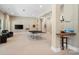 Spacious game room with ping pong table, TV, comfortable seating, and ample lighting at 14515 Nolen Ln, Charlotte, NC 28277