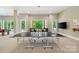 Spacious game room featuring a ping pong table and comfortable seating area by the bright windows at 14515 Nolen Ln, Charlotte, NC 28277
