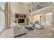 Expansive living area with high ceilings, a media center, and an open floor plan at 14515 Nolen Ln, Charlotte, NC 28277