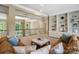 Spacious living room featuring neutral carpet, a ceiling fan, an ottoman and built-in shelving at 14515 Nolen Ln, Charlotte, NC 28277