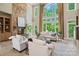 Spacious living room with a stone fireplace, tall windows, and comfortable seating at 14515 Nolen Ln, Charlotte, NC 28277