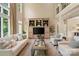 Bright living room with high ceilings, a built-in media center, and ample seating at 14515 Nolen Ln, Charlotte, NC 28277