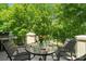 Outdoor patio with dining set and beautiful green backdrop perfect for enjoying the weather at 14515 Nolen Ln, Charlotte, NC 28277