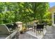 Outdoor patio with dining set, lush green background, and a grill for outdoor cooking at 14515 Nolen Ln, Charlotte, NC 28277