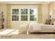 Bright main bedroom with lots of windows, light-colored walls, plush bed, and seating area at 1516 Croydon St, Indian Land, SC 29707