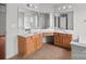Bright primary bathroom featuring double sinks, wooden cabinets, and large mirrors at 1534 Piney Church Rd, Concord, NC 28025