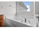 Bright bathtub with clear window view and chrome fixtures, creating a spa-like ambiance at 1534 Piney Church Rd, Concord, NC 28025
