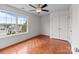Light-filled bedroom with double door closet, large window, and ceiling fan at 1534 Piney Church Rd, Concord, NC 28025