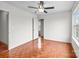 Bright bedroom with ceiling fan, neutral walls, and wood-look flooring at 1534 Piney Church Rd, Concord, NC 28025