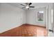 Bright bedroom with ceiling fan, natural light, and wood-look flooring at 1534 Piney Church Rd, Concord, NC 28025