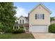 Two-story home features a light yellow exterior, attached garage, and blue shutters at 1534 Piney Church Rd, Concord, NC 28025
