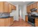 Kitchen featuring wood cabinets, stainless appliances and dark granite countertops at 1534 Piney Church Rd, Concord, NC 28025