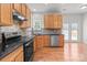 Kitchen with stainless steel appliances, wood cabinets, and granite counters at 1534 Piney Church Rd, Concord, NC 28025