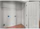 Functional laundry room with tile flooring, shelving, and washer/dryer hookups at 1534 Piney Church Rd, Concord, NC 28025