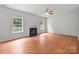 Bright living room with fireplace, two windows, and wood-look floors at 1534 Piney Church Rd, Concord, NC 28025