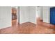 The living room with parquet floors provides access to the kitchen and a blue door at 1534 Piney Church Rd, Concord, NC 28025