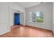 Bright living room featuring a large window and blue front door at 1534 Piney Church Rd, Concord, NC 28025
