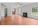 Living room with fireplace, kitchen view, and natural light from two windows at 1534 Piney Church Rd, Concord, NC 28025