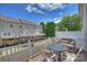 Inviting back deck features comfortable seating with views of the lawn and townhouse exteriors at 15639 Sir Charles Pl, Charlotte, NC 28277