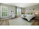 Bright bedroom featuring a dedicated desk area and large windows, offering ample natural light at 15639 Sir Charles Pl, Charlotte, NC 28277