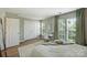 Cozy bedroom with a dedicated desk space, large windows and a neutral color palette at 15639 Sir Charles Pl, Charlotte, NC 28277