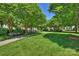 Lush green common area with mature trees and walking path provides a serene environment at 15639 Sir Charles Pl, Charlotte, NC 28277