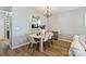 Dining room with wood table set, chandelier, and view to the kitchen at 15639 Sir Charles Pl, Charlotte, NC 28277