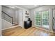 Entryway featuring wood floors, access to stairs, and a window at 15639 Sir Charles Pl, Charlotte, NC 28277
