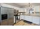 Well-lit kitchen with stainless steel appliances and white cabinetry at 15639 Sir Charles Pl, Charlotte, NC 28277