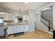 Well-lit kitchen featuring hard wood floors, stainless steel sink, and view to the staircase at 15639 Sir Charles Pl, Charlotte, NC 28277
