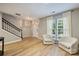 Bright living room features new floors, light walls, front entrance, and natural light at 15639 Sir Charles Pl, Charlotte, NC 28277