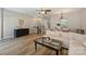 Open living space features hard wood floors, staircase, decor, and a large sectional sofa at 15639 Sir Charles Pl, Charlotte, NC 28277