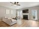 Spacious living room with fireplace, ceiling fan, and a sliding glass door at 15639 Sir Charles Pl, Charlotte, NC 28277