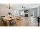 Spacious living room with fireplace, ceiling fan, dining area, and plenty of natural light at 15639 Sir Charles Pl, Charlotte, NC 28277