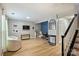 Light filled living area offers stylish blue accent wall, modern light fixture, and durable flooring at 15639 Sir Charles Pl, Charlotte, NC 28277