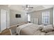 Spacious main bedroom features a large bed, ceiling fan, and ample natural light at 15639 Sir Charles Pl, Charlotte, NC 28277